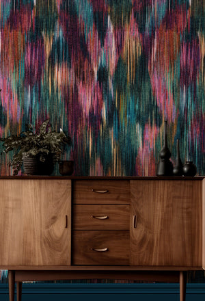 Spectre Ikat wallpaper by Victoria Sanders in multicolour, a blurred ikat design above a cabinet