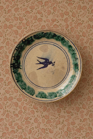 Annabelle wallpaper by Curate Space in peach, ditsy hand-painted florals behind a decorative plate hung on the wall