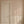 Dilys wallpaper by Curate Space in plaster beige, a floral stripe in a hallway with a white panelled door