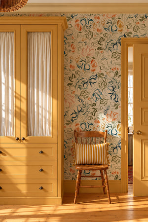 Eva wallpaper by Curate Space in off-white, a large-scale painterly floral in a room with yellow cabinets