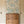Eva wallpaper by Curate Space in off-white, a large-scale painterly floral in a hallway with a wooden chest of drawers