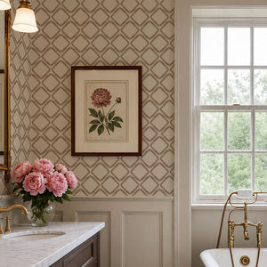Florence wallpaper by Curate Space in rust orange, a leaf-lined diamond lattice in a bathroom with a freestanding bath and framed botanical print