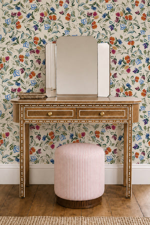 Freya wallpaper by Curate Space in off-white, loose painterly flowers and leaves behind a dressing table with a pink stool