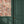 Freya wallpaper by Curate Space in soft pink, loose painterly flowers and leaves in a hallway above green panelling