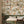 Iris wallpaper by Curate Space in off-white, botanical blooms and foliage in a dining nook with wooden chairs
