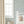 Jude wallpaper by Curate Space in blue, insects on a soft check in a nursery with a white cot