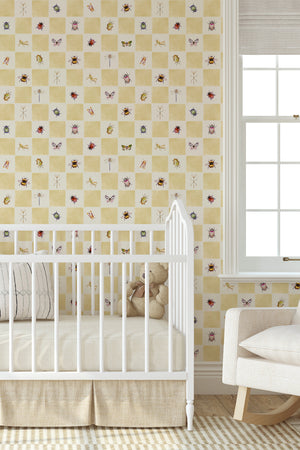 Jude wallpaper by Curate Space in butter yellow, insects on a soft check in a nursery with a white cot