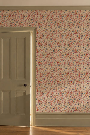 Little Freya wallpaper by Curate Space in soft pink, small abstract flowers and leaves in a hallway beside a panelled door