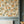 Lottie wallpaper by Curate Space in off-white, oversized chintz-style florals in a hallway with blue-grey panelling and a radiator