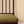 Mabel wallpaper by Curate Space in yellow, small rosette motifs behind a spindle chair with a green cushion