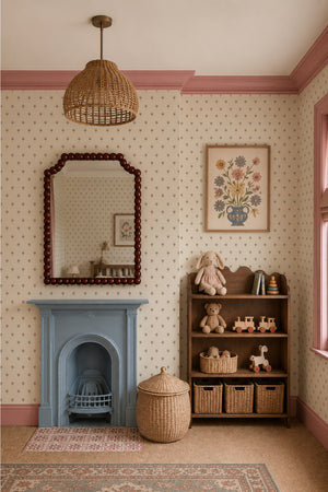 Madeline wallpaper by Curate Space in parchment cream, fan-shaped floral motifs in a room with a blue fireplace and beaded mirror