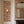 Margot wallpaper by Curate Space in pastel pink and sage green, painterly roses and wildflowers in a panelled alcove with a mirror