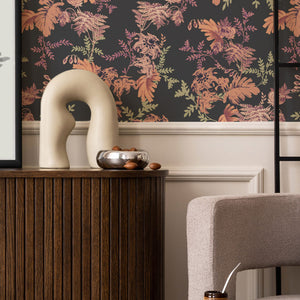 Mina wallpaper by Curate Space in midnight blue, dramatic layered florals and foliage in a living room with a wooden sideboard and a sculptural vase