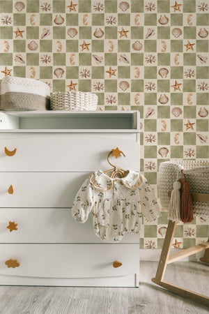 Molly wallpaper by Curate Space in soft green, seashells and seahorses on a check in a nursery with a white changing table