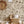 Noah wallpaper by Curate Space in pebble grey, palm trees, tropical foliage and animals in a nursery with a rattan sun mirror