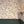 Paloma wallpaper by Curate Space in off-white, trailing floral stems in a hallway above deep green panelling