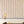 Ren wallpaper by Curate Space in off-white, wavy stripes with bugs and butterflies in a nursery with a wooden cot