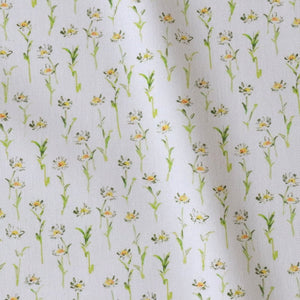 Betsy Flora linen by Seed Home Designs in yellow and green, draped, showing delicate ditsy flowers