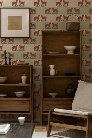 A Leopard Never Changes His Spots wallpaper by Annika Reed in cream, leaping leopards in a living room
