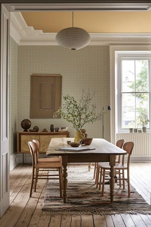 Solstice Sun wallpaper by Annika Reed in blue and orange, suns in a lattice in a dining area