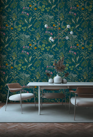 Eden wallpaper by Deus ex Gardenia in teal, lush leaves and fruit in a dining area