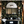 Eden wallpaper by Deus ex Gardenia in black, lush leaves and fruit in a bathroom