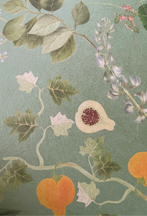 Eden wallpaper by Deus ex Gardenia in sage green, detail of lush leaves and fruit