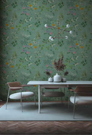 Eden wallpaper by Deus ex Gardenia in sage green, lush leaves and fruit on a living room wall