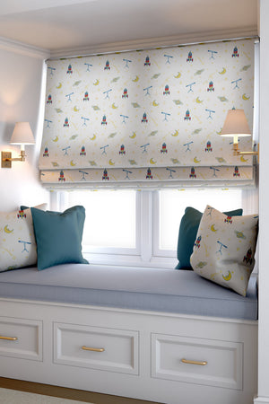 Float Away into Space linen by Annika Reed in cream, rockets, moons and planets as a roman blind