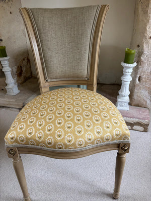 Folly linen by Parker and Jules in mustard, sunburst medallions on an upholstered chair
