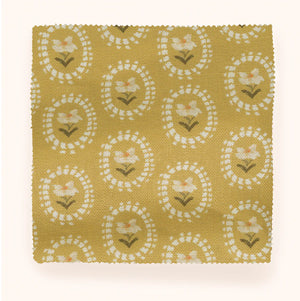 Folly linen by Parker and Jules in mustard, draped, showing sunburst medallions