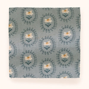 Folly linen by Parker and Jules in blue, draped, showing sunburst medallions