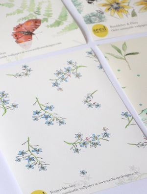 Forget Me Not wallpaper by Seed Home Designs in blue and green, full repeat of scattered forget-me-nots