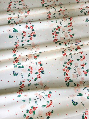 Frida linen by Claire de Quénetain in cream, draped, showing a hand-painted floral design