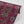 Garden of India wallpaper by Tatie Lou in burgundy, partly unrolled roll showing an Indian-style garden medallion