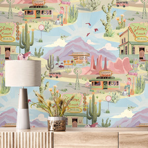 The Glitter Ranch wallpaper by Brand McKenzie in pink and blue, a desert ranch scene above a cabinet