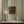 Somerset Stripes wallpaper by Annika Reed in green, painted stripes behind a console table