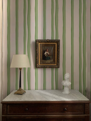 Somerset Stripes wallpaper by Annika Reed in green, painted stripes behind a console table