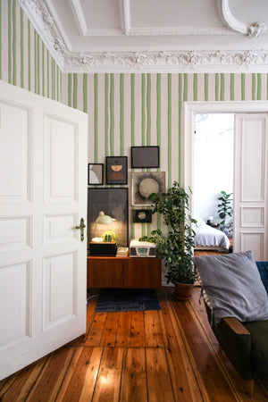 Somerset Stripes wallpaper by Annika Reed in green, painted stripes in a hallway
