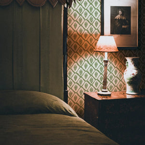 Jaipur wallpaper by Annika Reed in green, block-print medallions in a bedroom