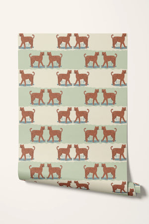 A Leopard Never Changes His Spots wallpaper by Annika Reed in orange and mint green, partly unrolled roll showing