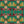 Hampi wallpaper by Tatie Lou in green, flat sample of tropical flowers in a mirrored print
