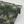 Hampi wallpaper by Tatie Lou in dark green, full repeat of tropical flowers in a mirrored print