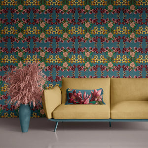 Hampi wallpaper by Tatie Lou in teal, tropical flowers in a mirrored print on a living room wall