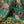 Hampi velvet by Tatie Lou in green, in soft folds showing tropical flowers in a mirrored print