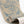 Harvest Hare wallpaper by St. Jude's in blue, partly unrolled roll showing hares among grasses