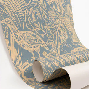 Harvest Hare wallpaper by St. Jude's in blue, partly unrolled roll showing hares among grasses