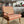 Heatwave linen by Bethie Tricks in orange and pink, wavy block-print stripes upholstered on an armchair