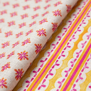 Heatwave linen by Bethie Tricks in orange and pink, draped, showing wavy block-print stripes