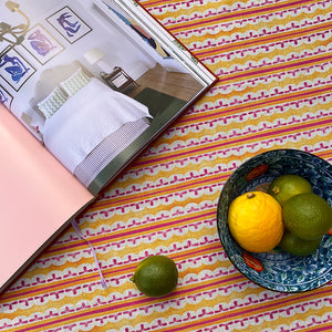 Heatwave linen by Bethie Tricks in orange and pink, close-up of wavy block-print stripes